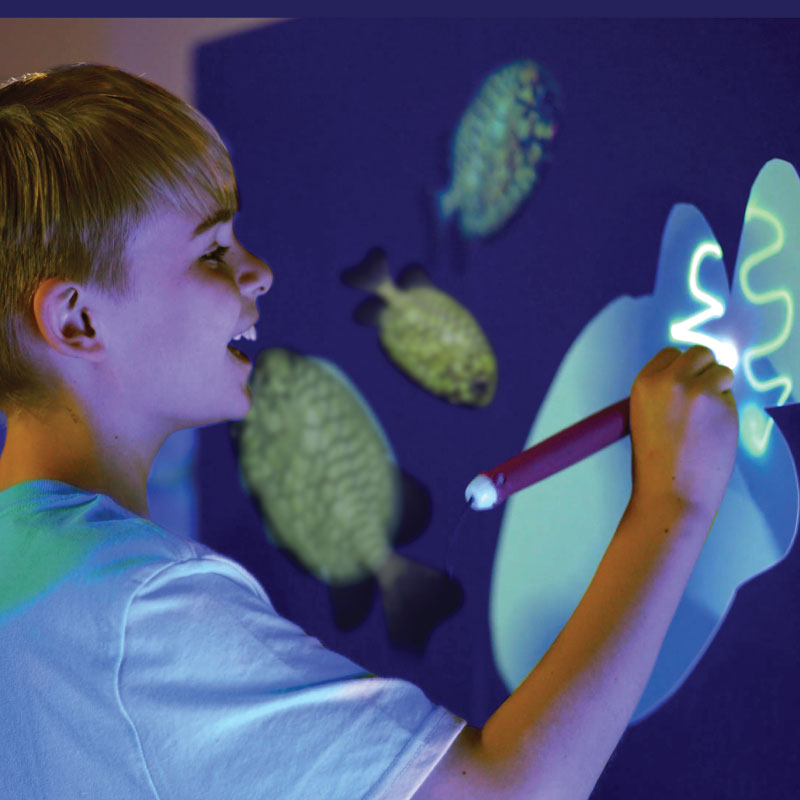 Kid drawing with light in a glowing underwater scene