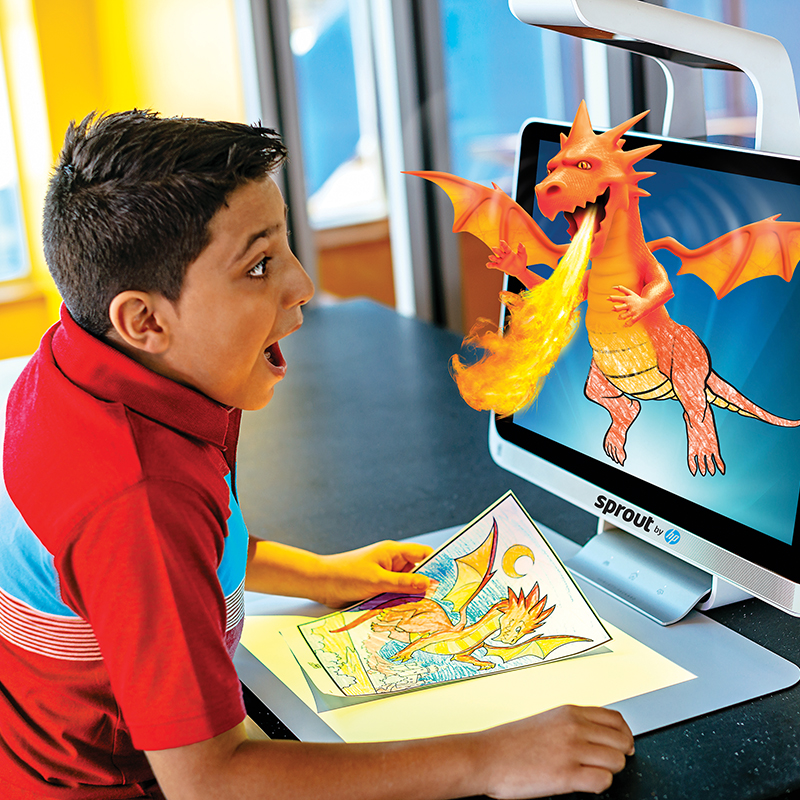 Boy with a dragon coming out of a computer screen at Color Magic at Crayola Experience