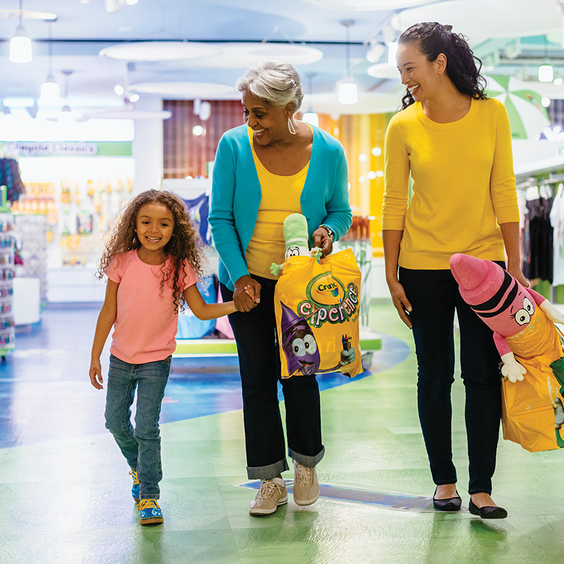 Family leaving The Crayola Store with merchandise