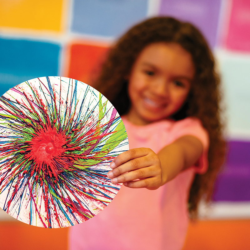 Young girl holding Spin Art