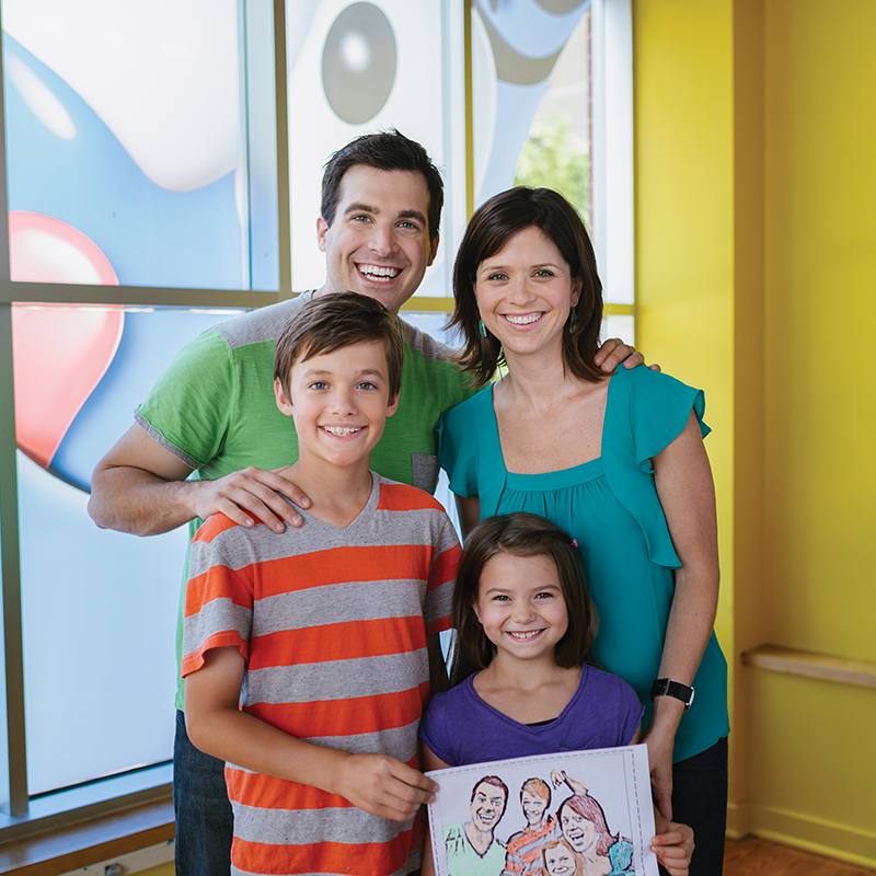 Family holding art at Crayola Experience