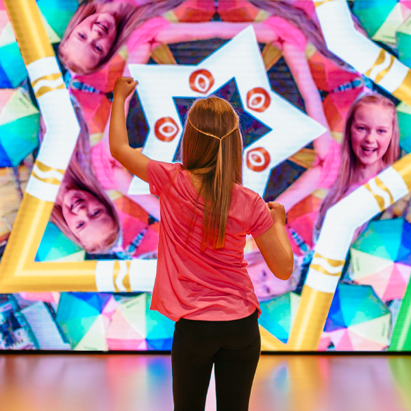 Girl in front of Kaleidoscope screen