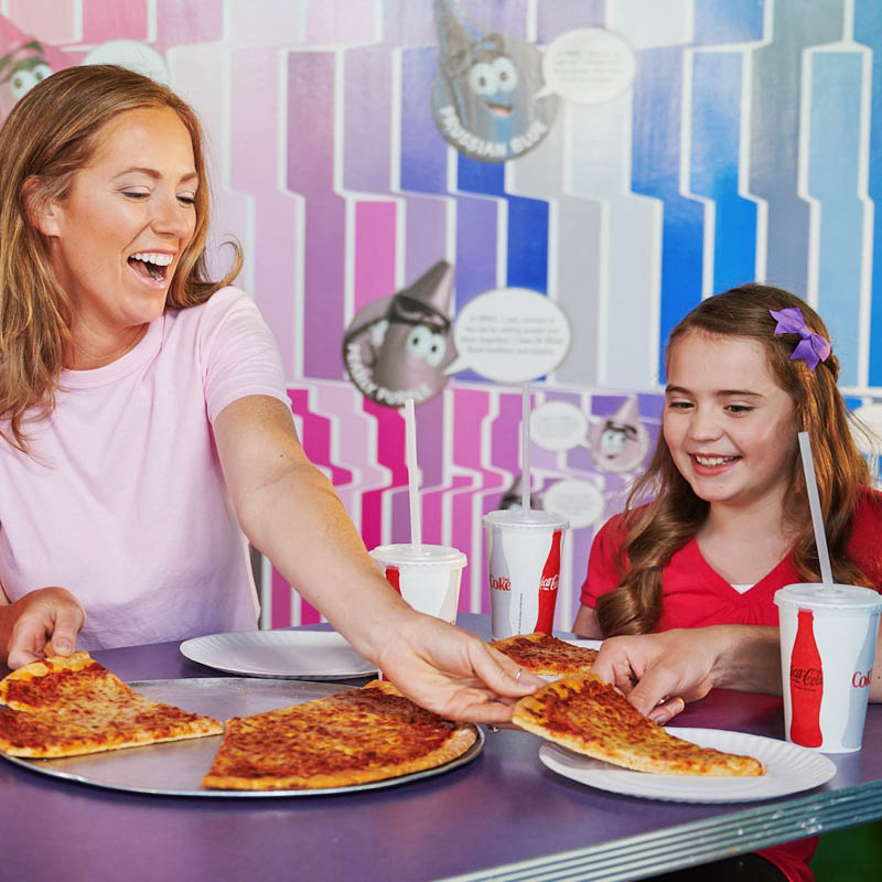 Family sharing a pizza at Cafe Crayola