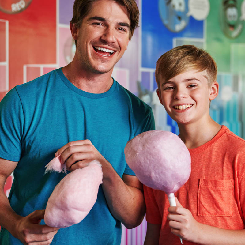 Adult and child holding cotton candy