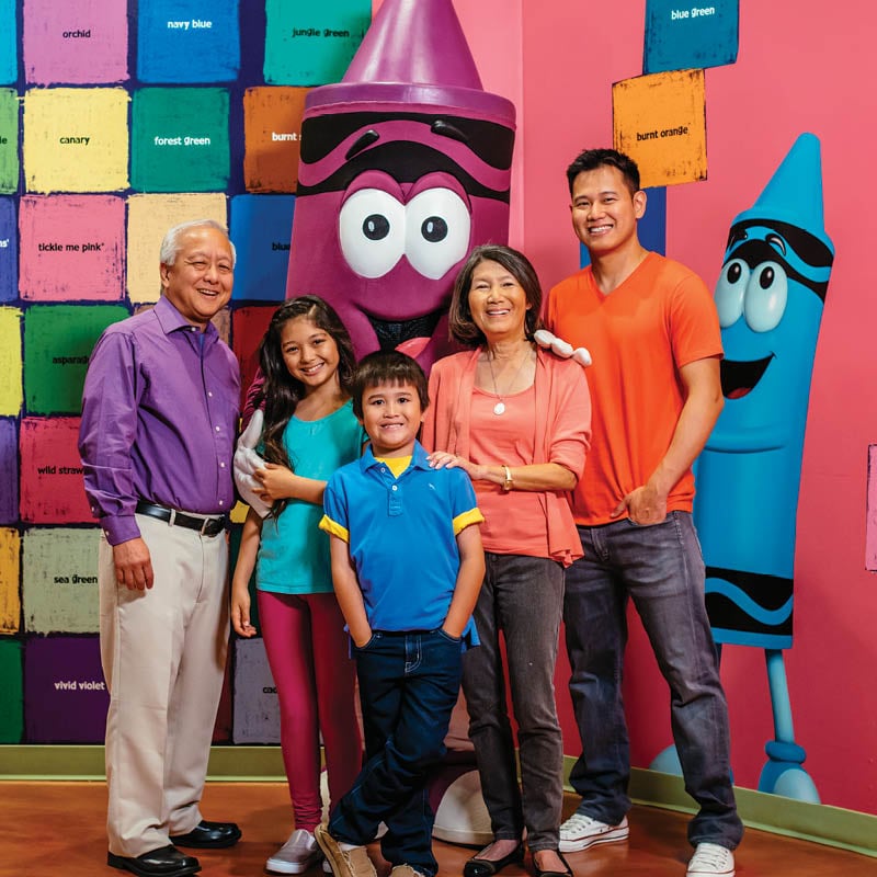 Family posing with an Orchid crayon character