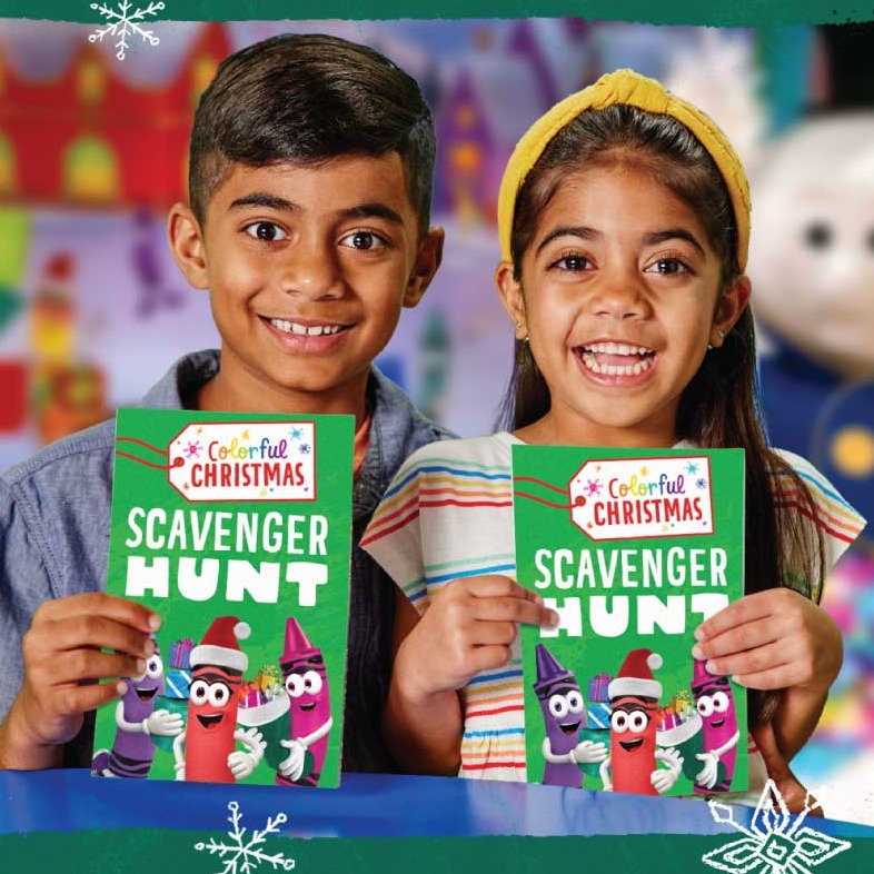 Two kids holding up holiday scavenger hunts