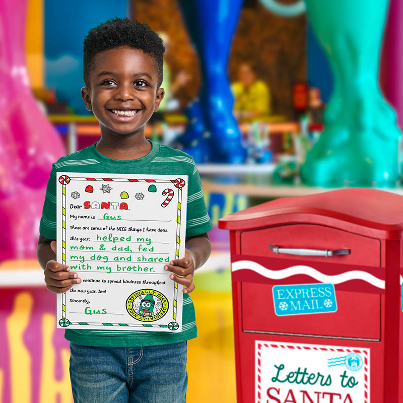 Child holding up a letter to Santa