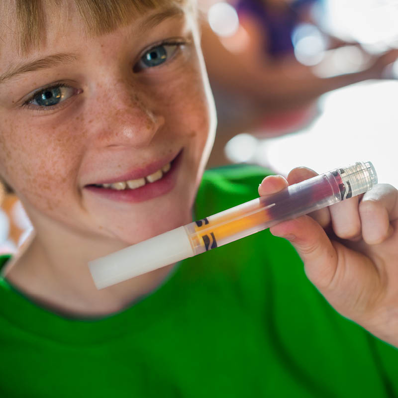 Child holding up a custom marker