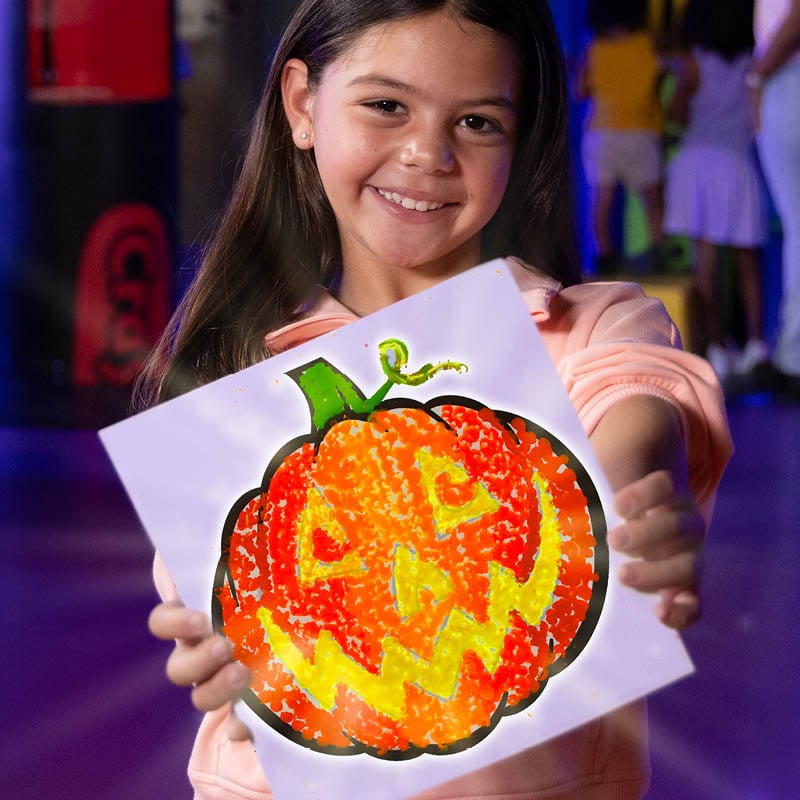 Child holding out melted wax art