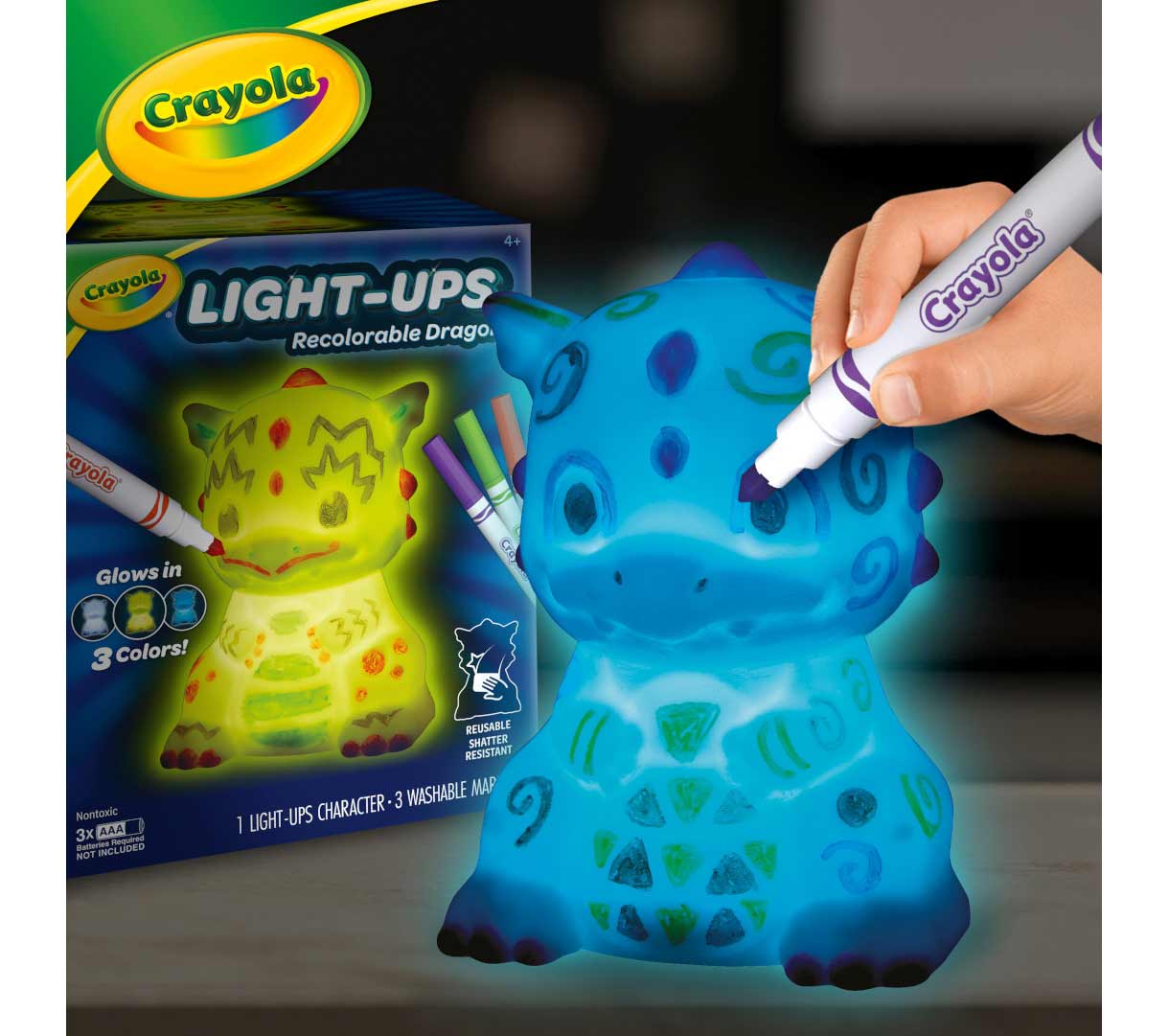 Light-Ups Dragon. Dragon being decorated with ultra-clean markers while glowing blue with packaging in the background.